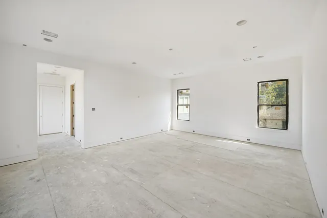 an empty room with windows and closet