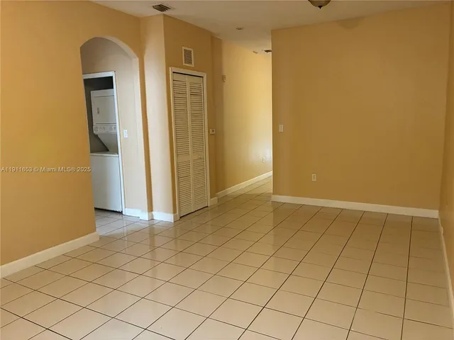 a view of a hallway with wooden cabinets