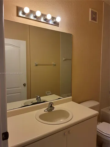 a bathroom with a shower and a sink
