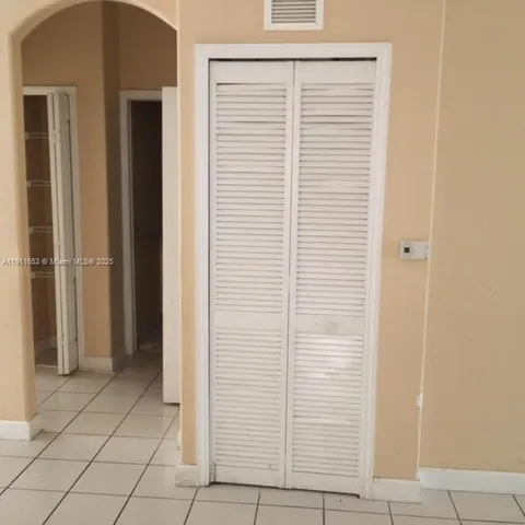 a white refrigerator freezer and a stove sitting inside of a kitchen