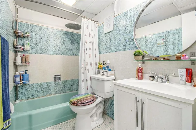 a bathroom with a sink a toilet and a mirror