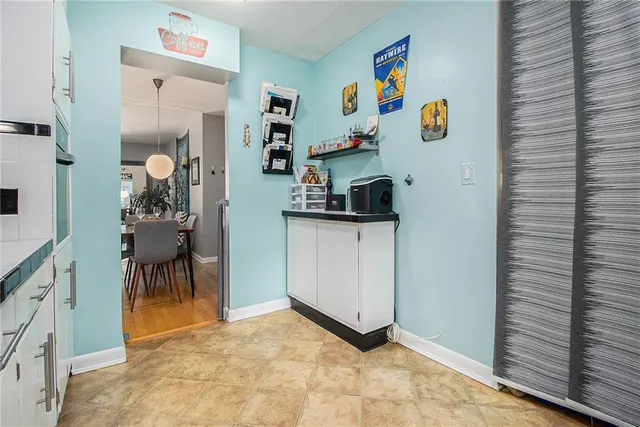a view of kitchen with furniture and refrigerator