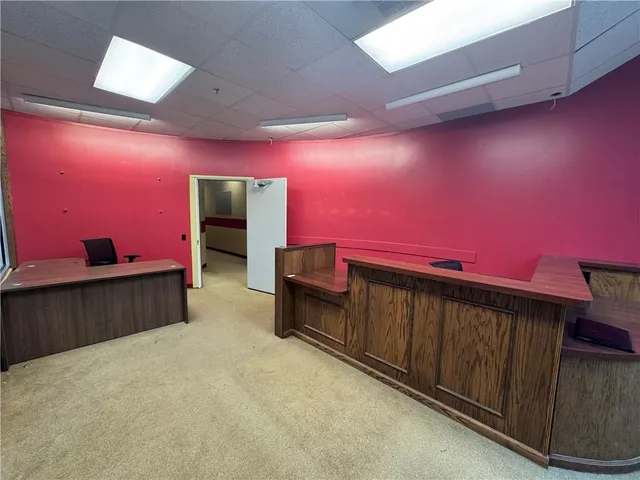 a spacious bedroom with a bed and a dresser