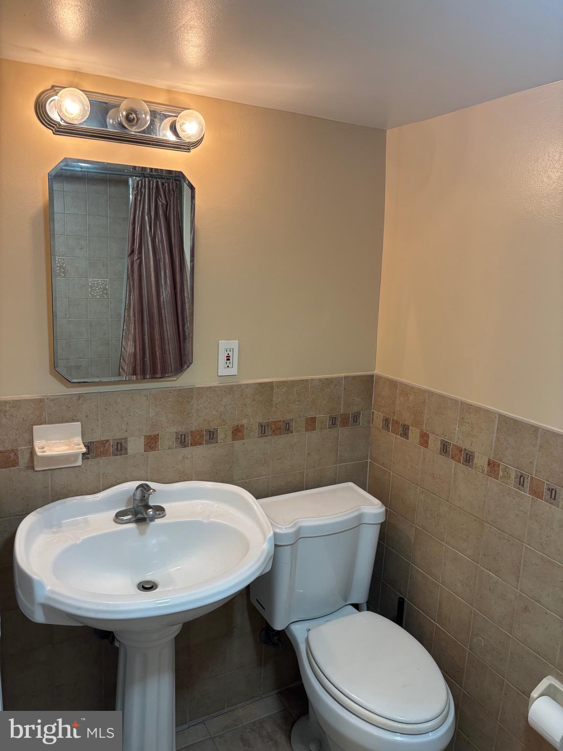6783 Ridge Avenue Philadelphia, PA 19128 - Photo 12 of 26 a bathroom with a toilet sink and mirror
