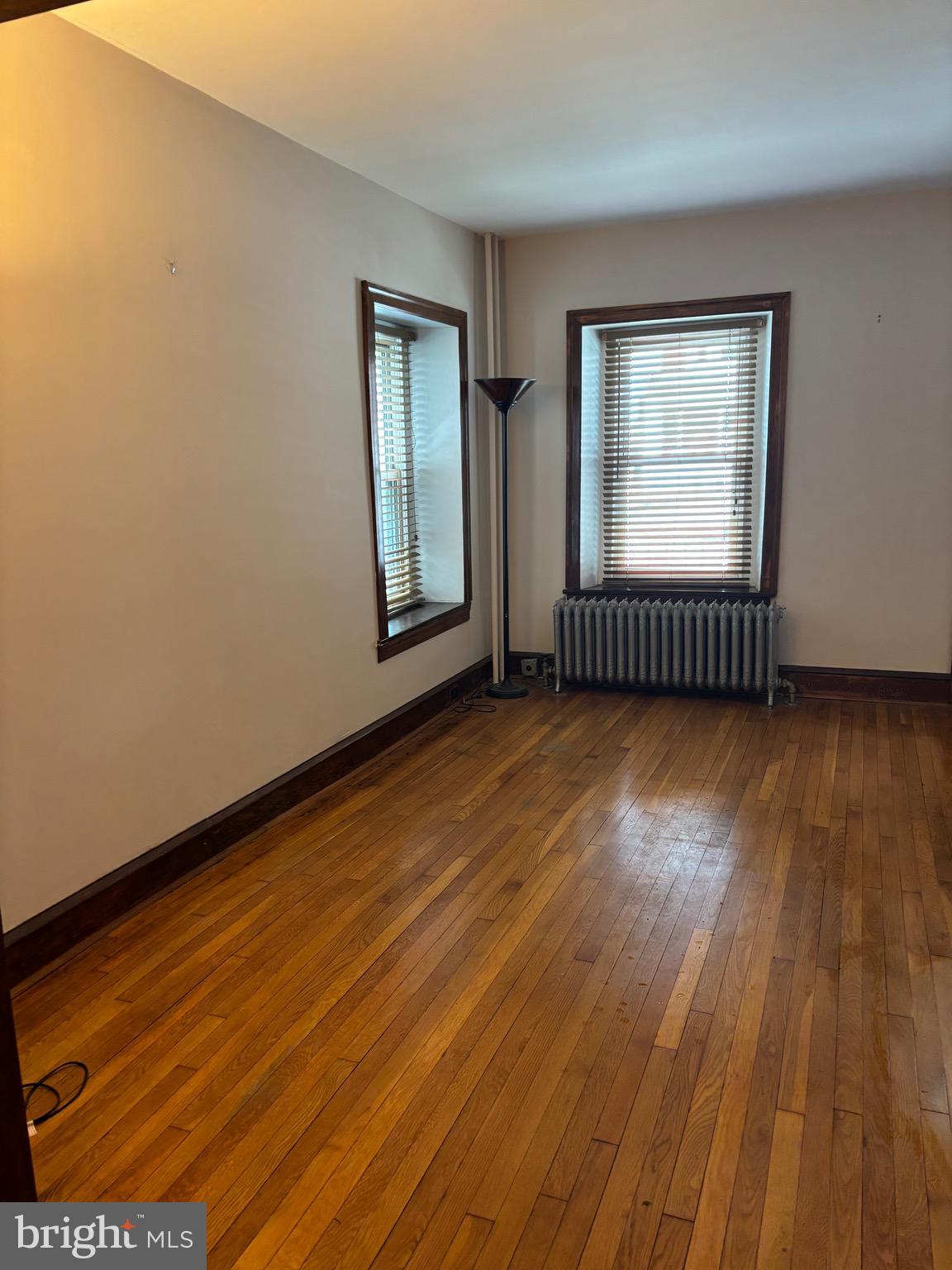 6783 Ridge Avenue Philadelphia, PA 19128 - Photo 5 of 26 an empty room with wooden floor and windows