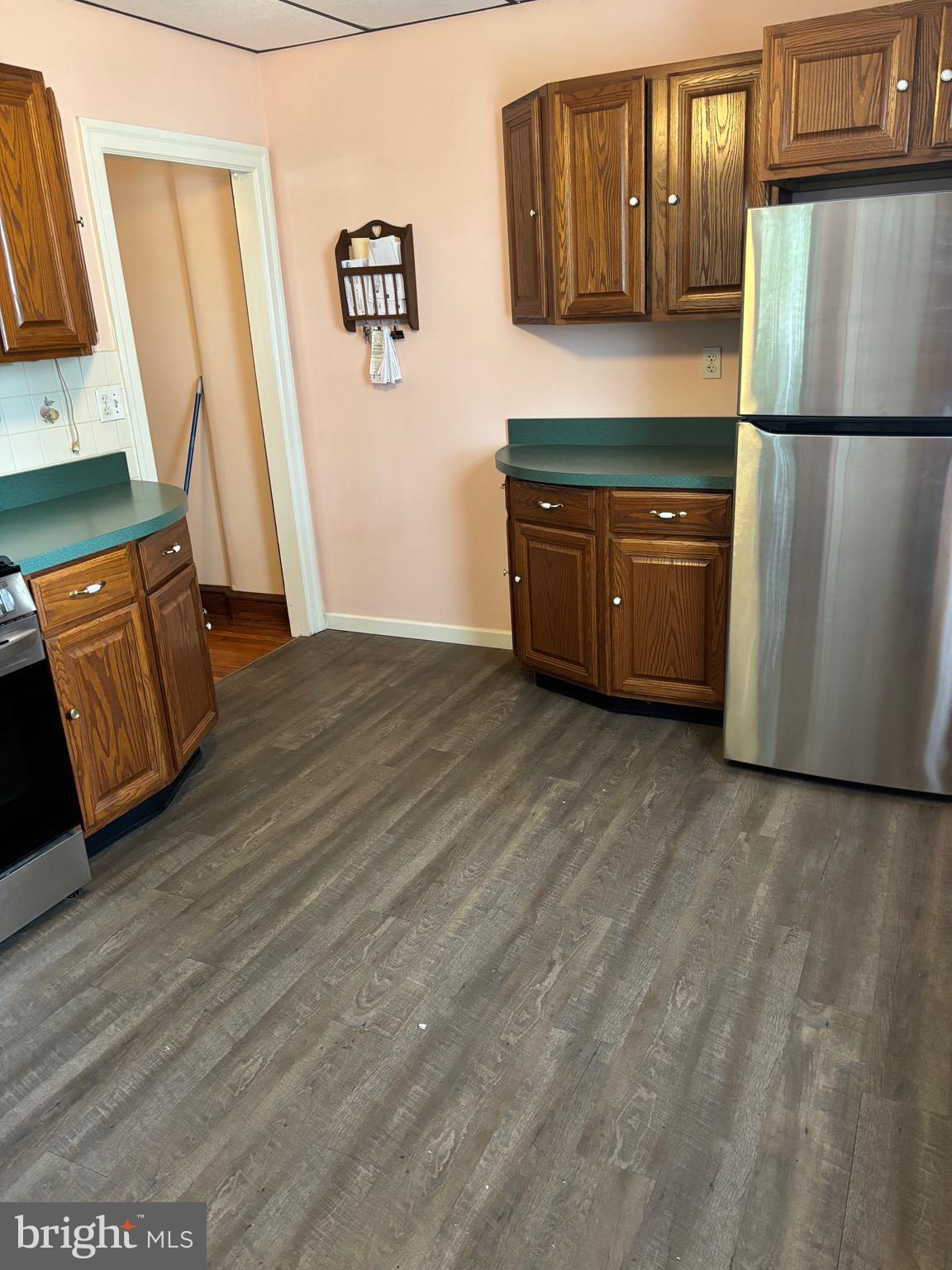 6783 Ridge Avenue Philadelphia, PA 19128 - Photo 8 of 26 a kitchen with granite countertop a refrigerator a sink a stove a microwave a counter top and cabinets