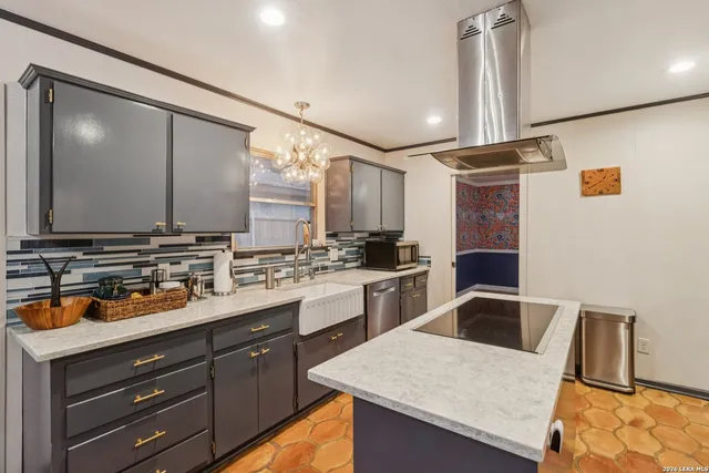 a kitchen with a sink a stove and cabinets