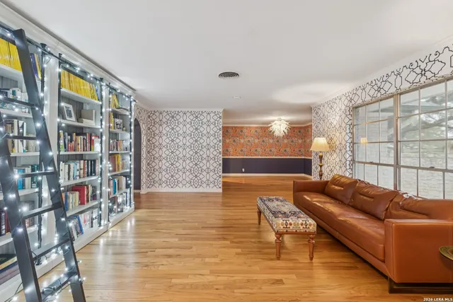 a living room with furniture and a book shelf