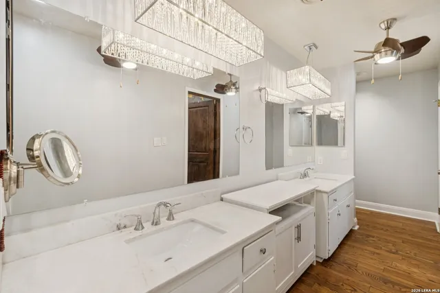 a spacious bathroom with a double vanity sink and a mirror