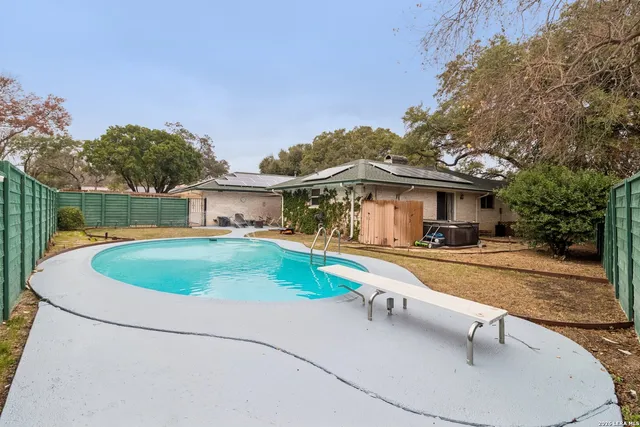 a house view with a swimming pool and porch