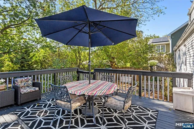 a view of a balcony with furniture and wooden floor