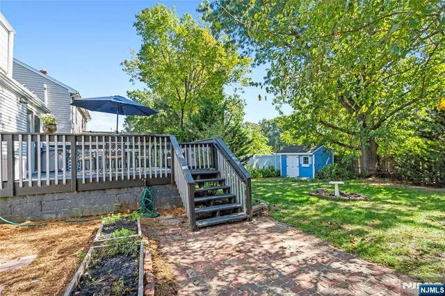 a view of a house with backyard and sitting area