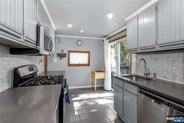 a kitchen with a sink stove and cabinets