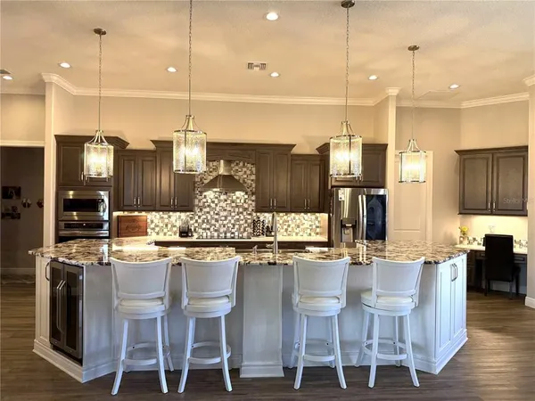 a bathroom with granite countertop a refrigerator and a sink