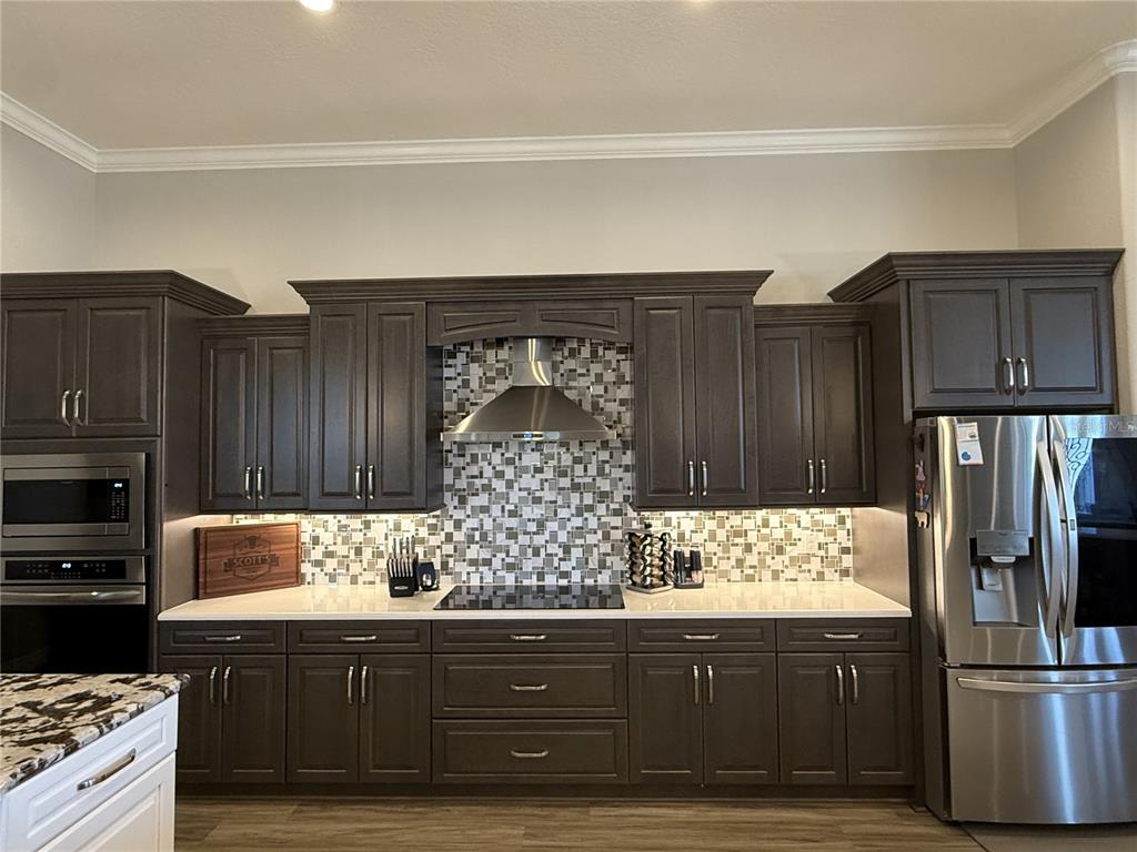 17898 Southwest 72nd Street Road Dunnellon, FL 34432 - Photo 18 of 85 a kitchen with granite countertop wooden cabinets and stainless steel appliances