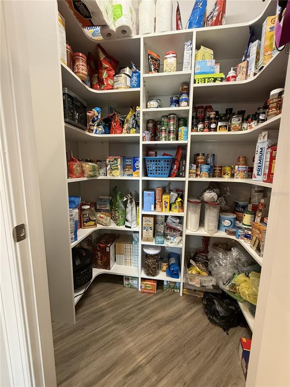 17898 Southwest 72nd Street Road Dunnellon, FL 34432 - Photo 24 of 85 a room with wooden floor and a book shelf