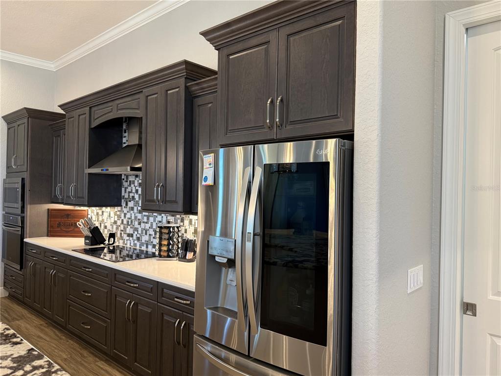 17898 Southwest 72nd Street Road Dunnellon, FL 34432 - Photo 26 of 85 a bathroom with granite countertop a refrigerator and a sink