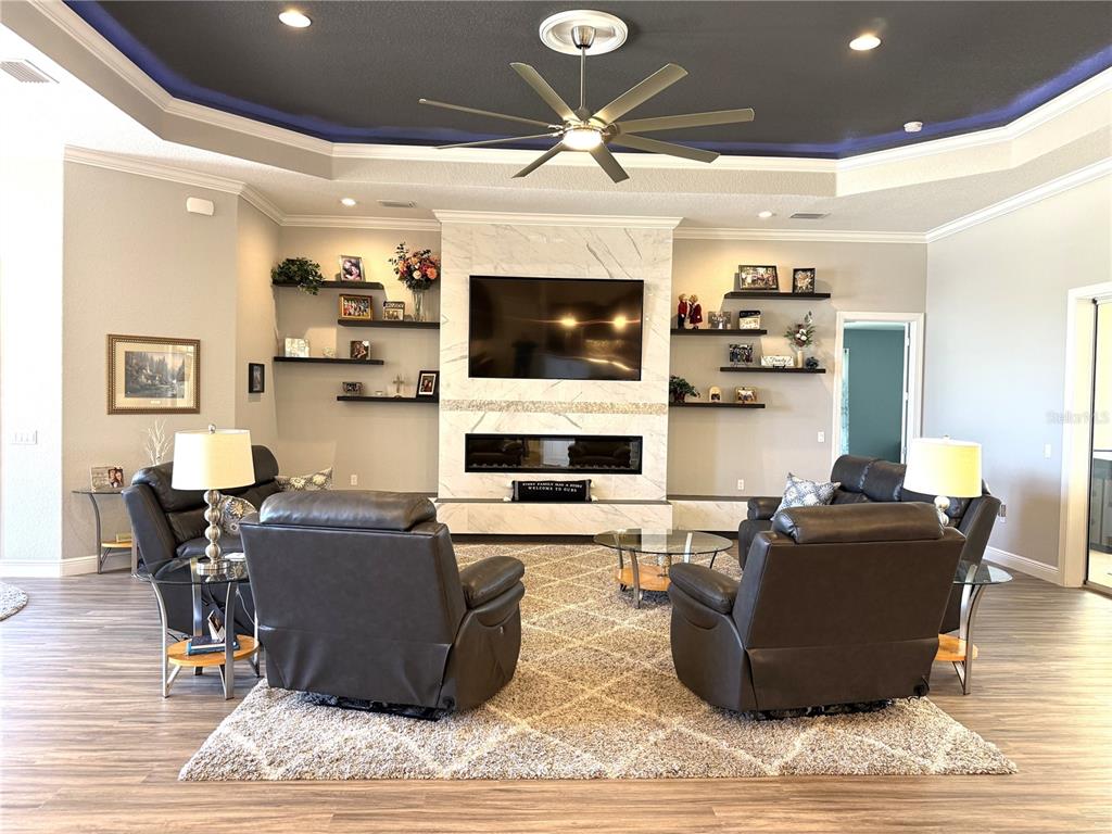 17898 Southwest 72nd Street Road Dunnellon, FL 34432 - Photo 29 of 85 a living room with fireplace furniture and a flat screen tv