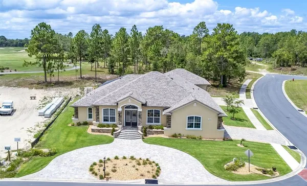 a aerial view of a house with a yard patio and fire pit