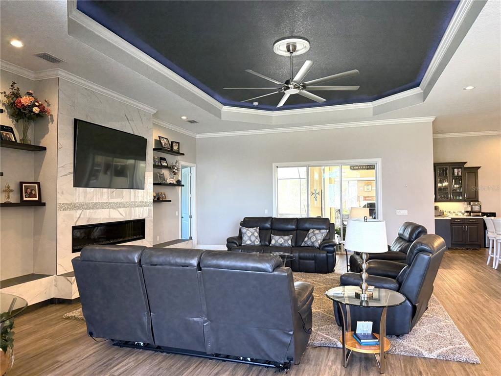 17898 Southwest 72nd Street Road Dunnellon, FL 34432 - Photo 32 of 85 a living room with furniture a fireplace and a flat screen tv