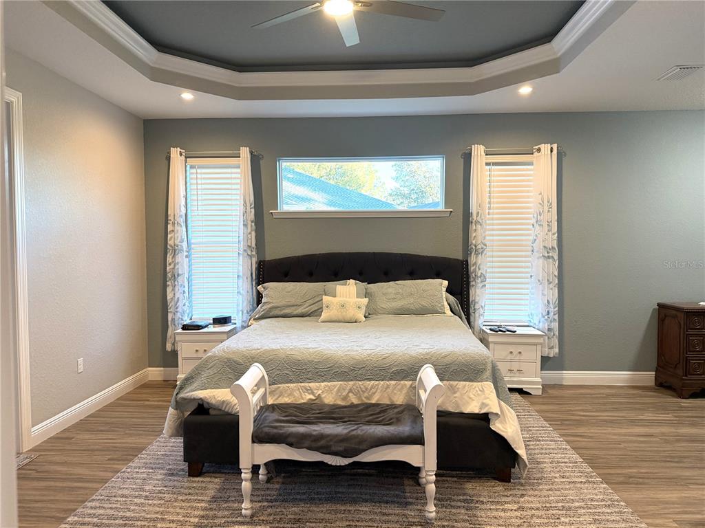 17898 Southwest 72nd Street Road Dunnellon, FL 34432 - Photo 33 of 85 a bedroom with a bed and wooden floor