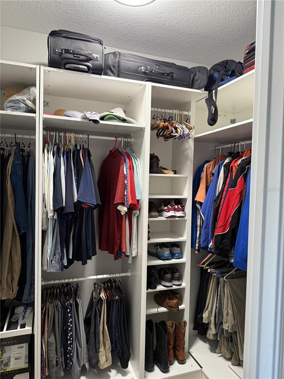 17898 Southwest 72nd Street Road Dunnellon, FL 34432 - Photo 36 of 85 a view of walk in closet with clothes and shoes