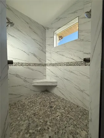 a view of a livingroom with furniture and a floor to ceiling window