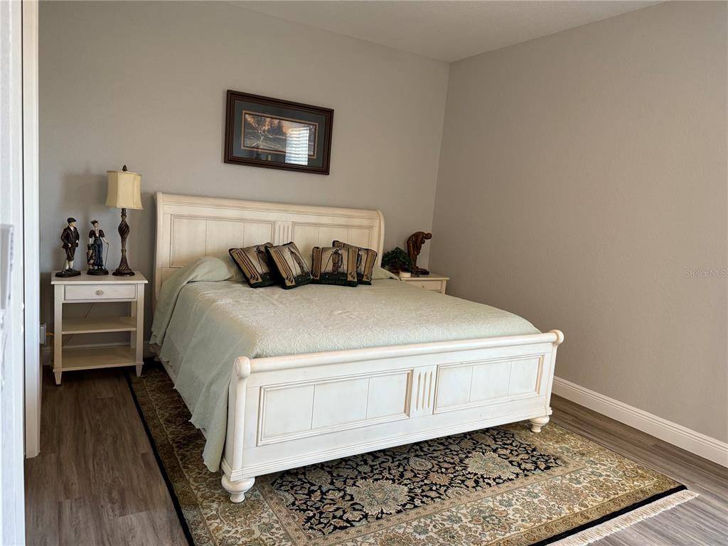 17898 Southwest 72nd Street Road Dunnellon, FL 34432 - Photo 47 of 85 a bed sitting in a bedroom and table