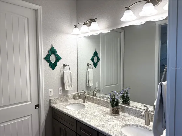a bathroom with a sink and mirror