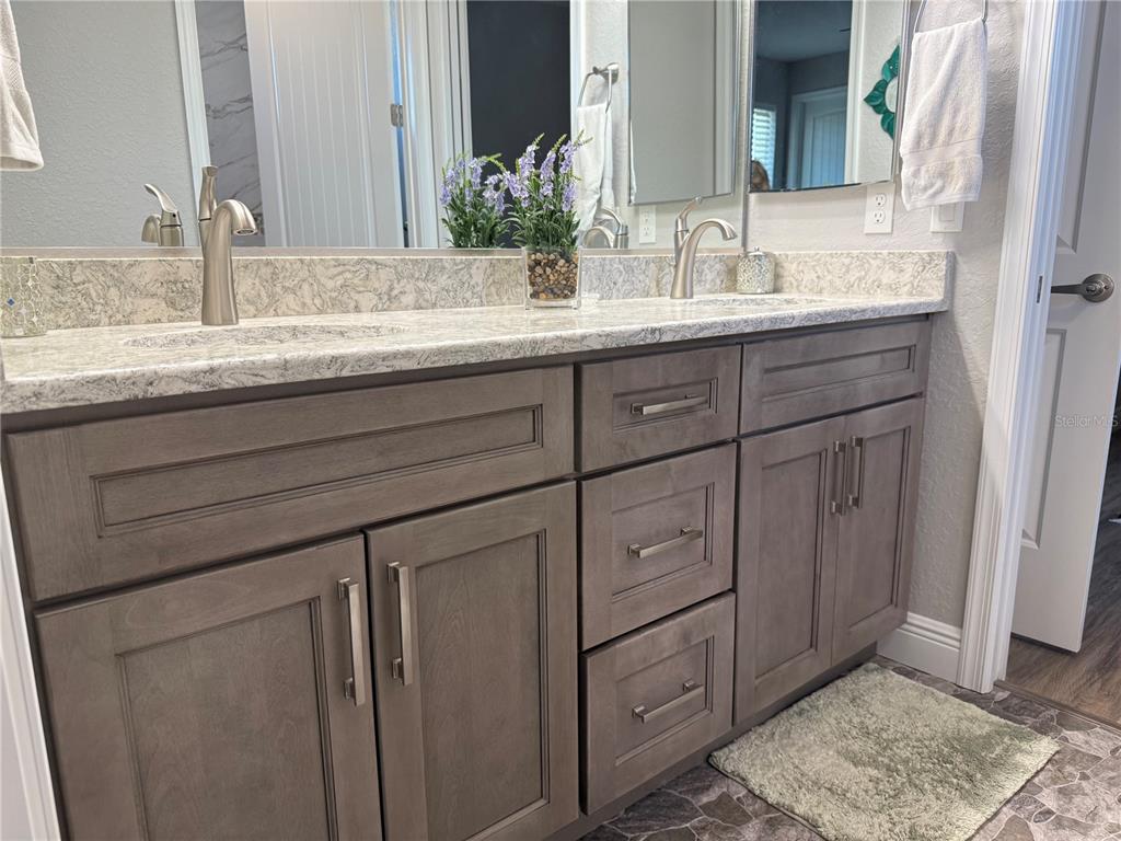 17898 Southwest 72nd Street Road Dunnellon, FL 34432 - Photo 52 of 85 a bathroom with a granite countertop sink and a mirror