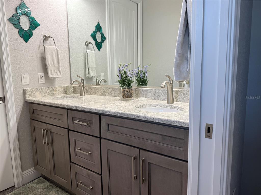 17898 Southwest 72nd Street Road Dunnellon, FL 34432 - Photo 53 of 85 a bathroom with a granite countertop sink and a mirror