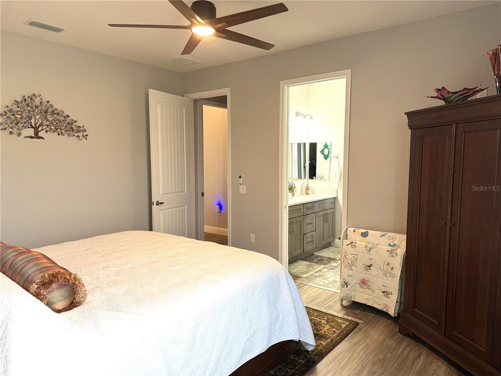17898 Southwest 72nd Street Road Dunnellon, FL 34432 - Photo 55 of 85 a bedroom with a bed and a chandelier