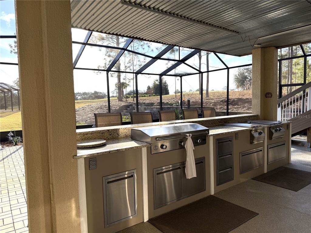 17898 Southwest 72nd Street Road Dunnellon, FL 34432 - Photo 66 of 85 a view of a large white kitchen with a large window
