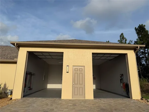 a dining room with wooden floor and kitchen view