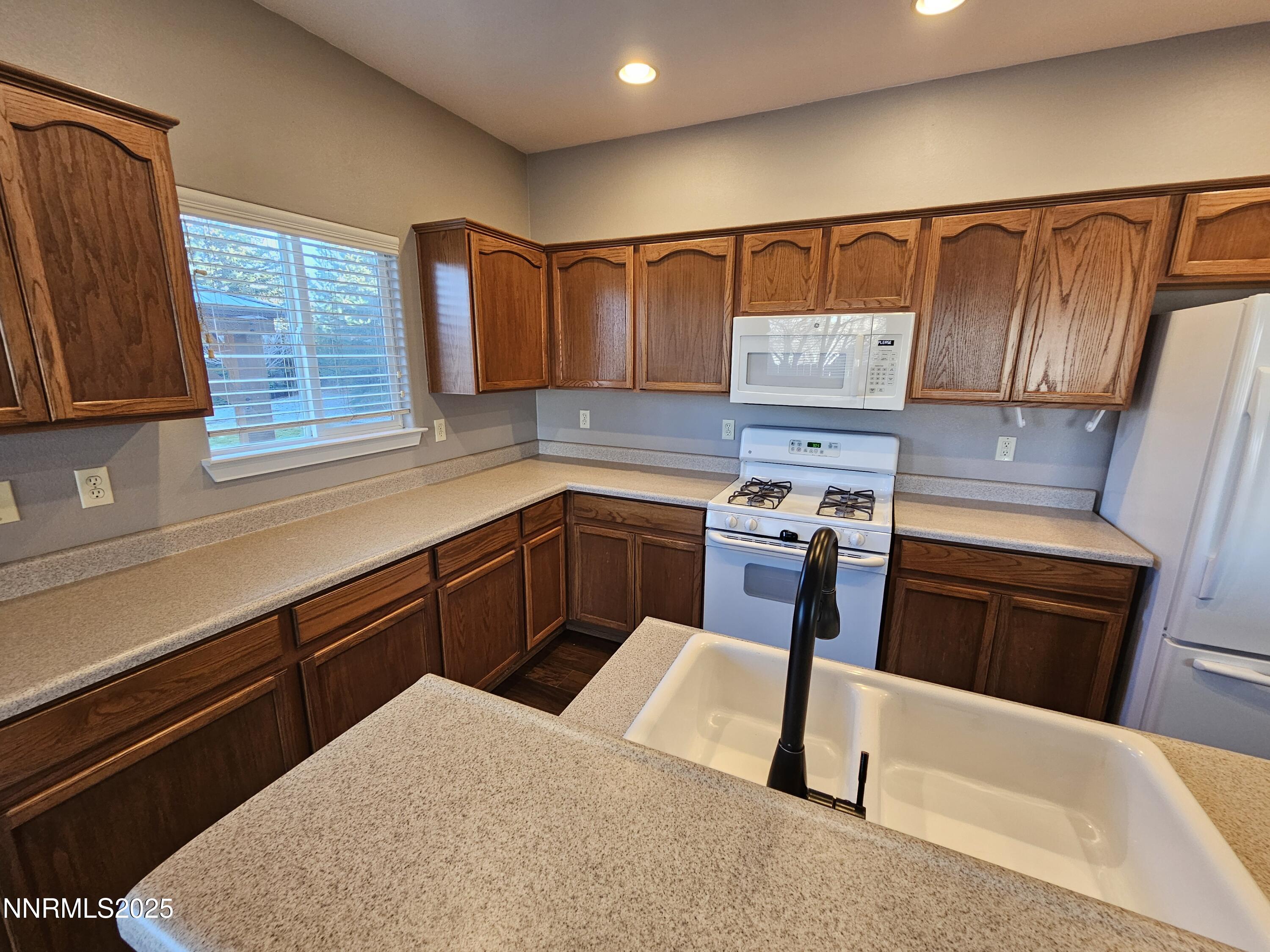 7698 Quarry Rock Court Reno, NV 89506 - Photo 14 of 33 a kitchen with a sink cabinets and window