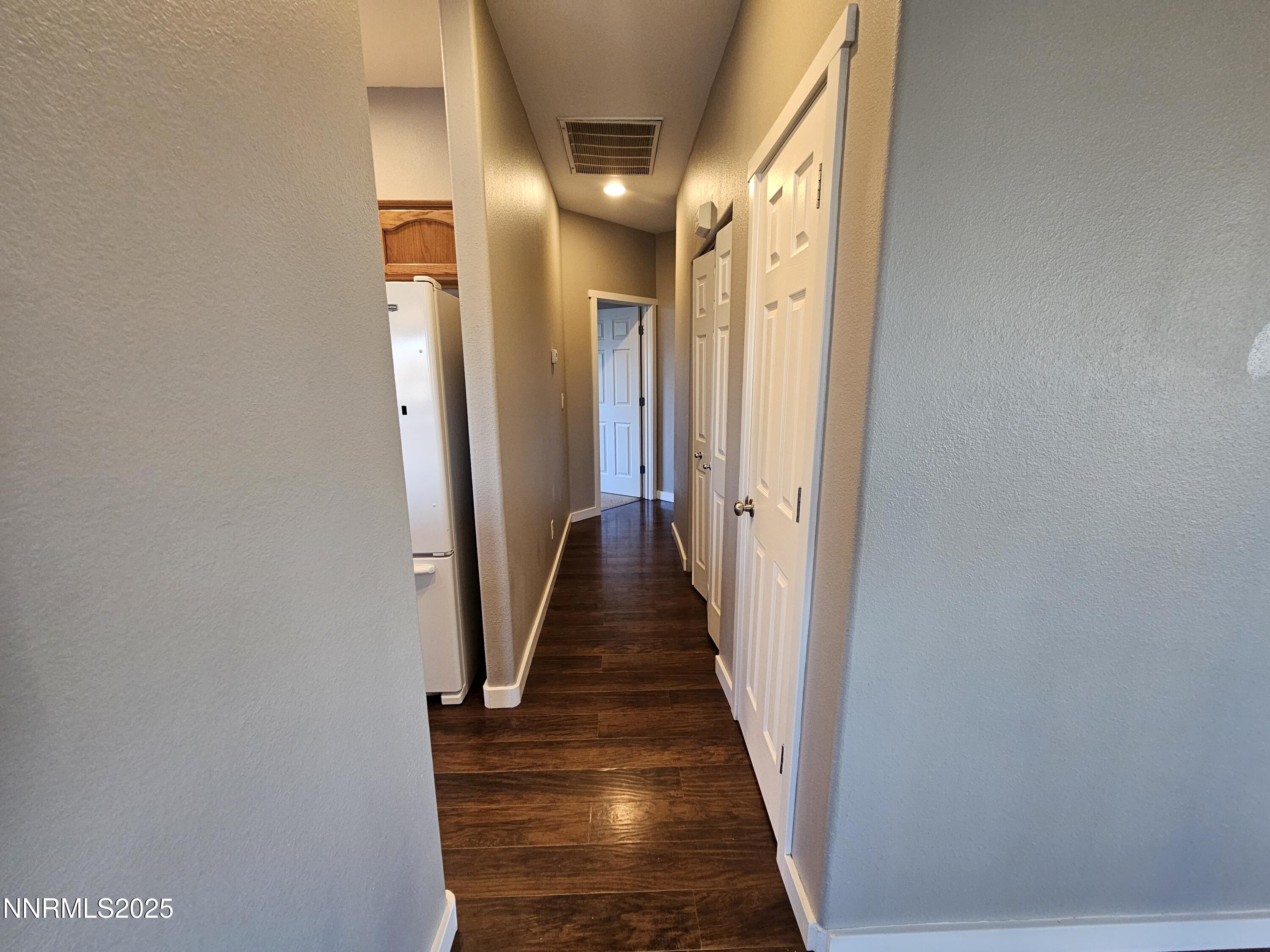 7698 Quarry Rock Court Reno, NV 89506 - Photo 20 of 33 a view of a hallway with wooden floor and staircase