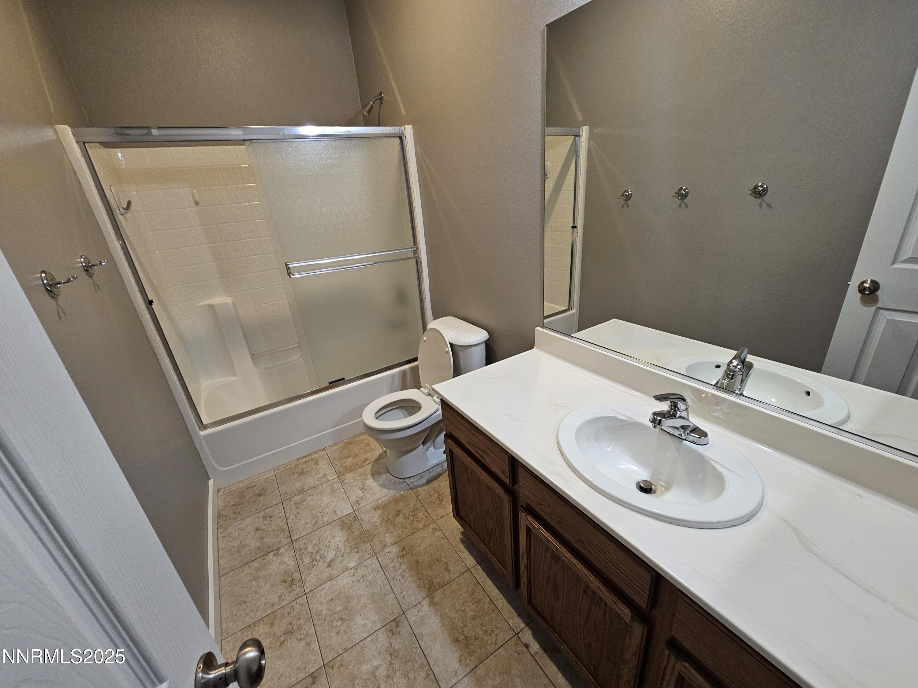 7698 Quarry Rock Court Reno, NV 89506 - Photo 21 of 33 a bathroom with a sink a toilet a mirror and shower