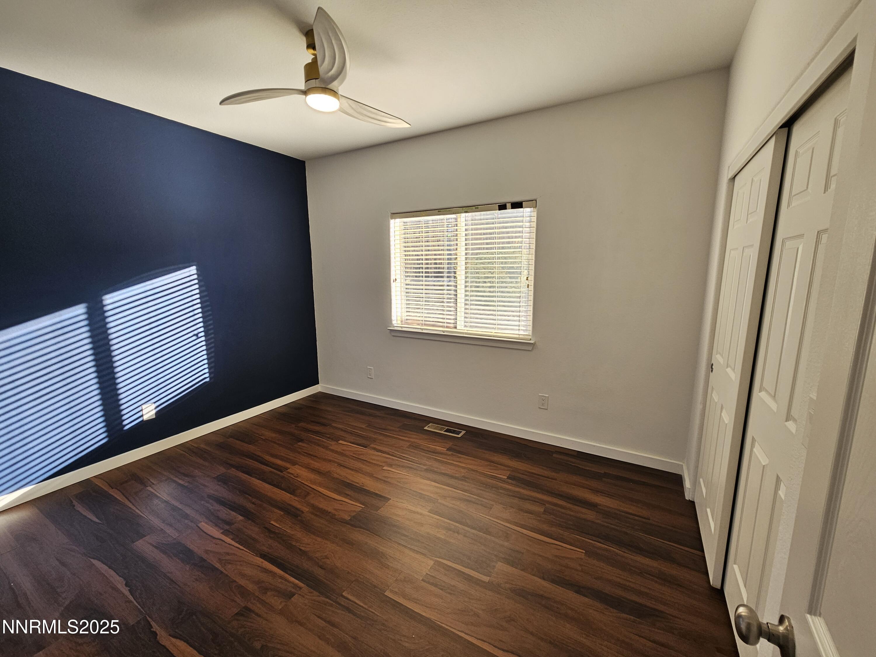 7698 Quarry Rock Court Reno, NV 89506 - Photo 23 of 33 a view of an empty room with wooden floor and a window