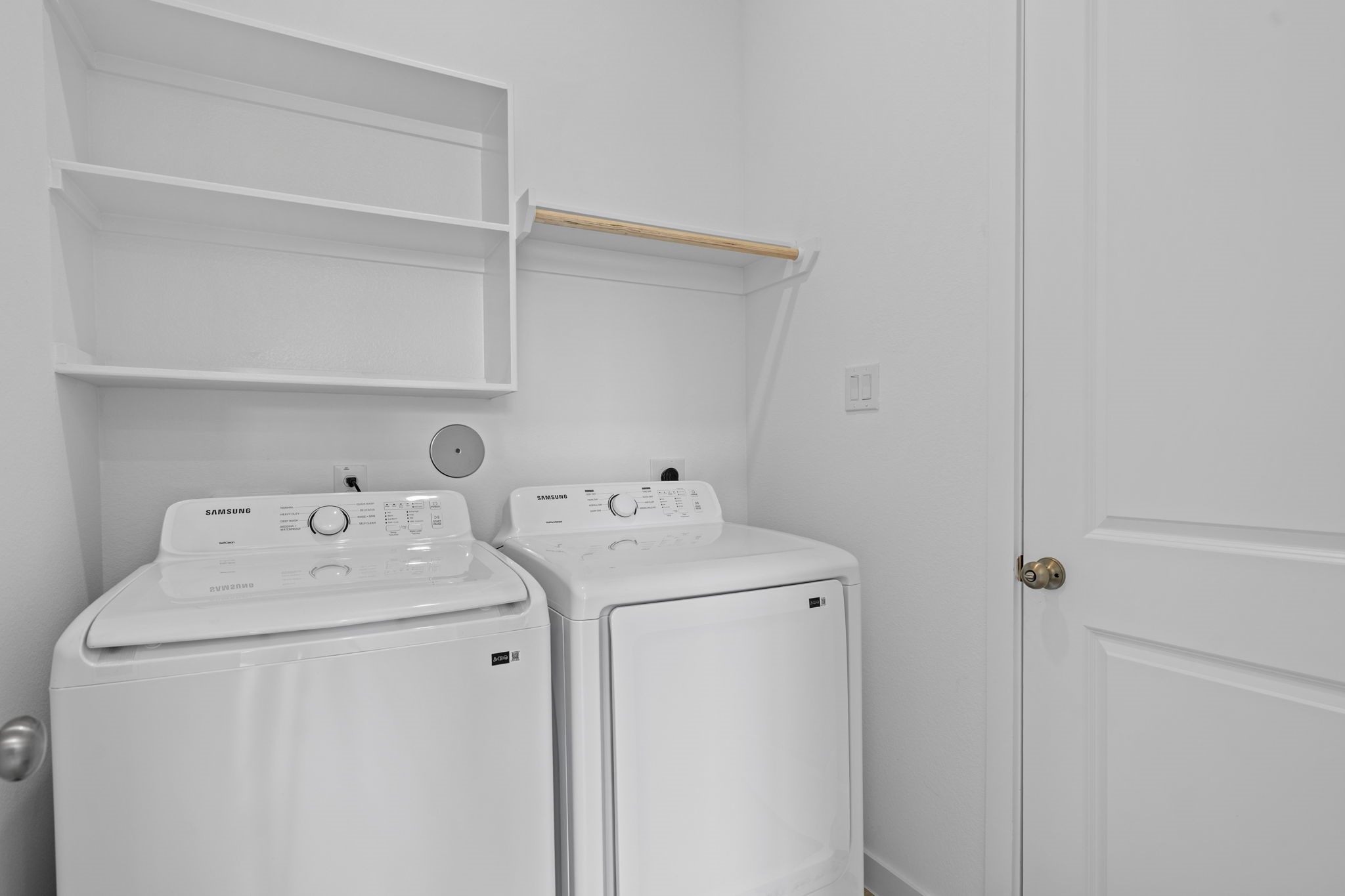 2720 Grove Crest Drive Rosenberg, TX 77469 - Photo 27 of 32 Convenient laundry room equipped with washer and dryer, featuring built-in shelving for added storage and organization.