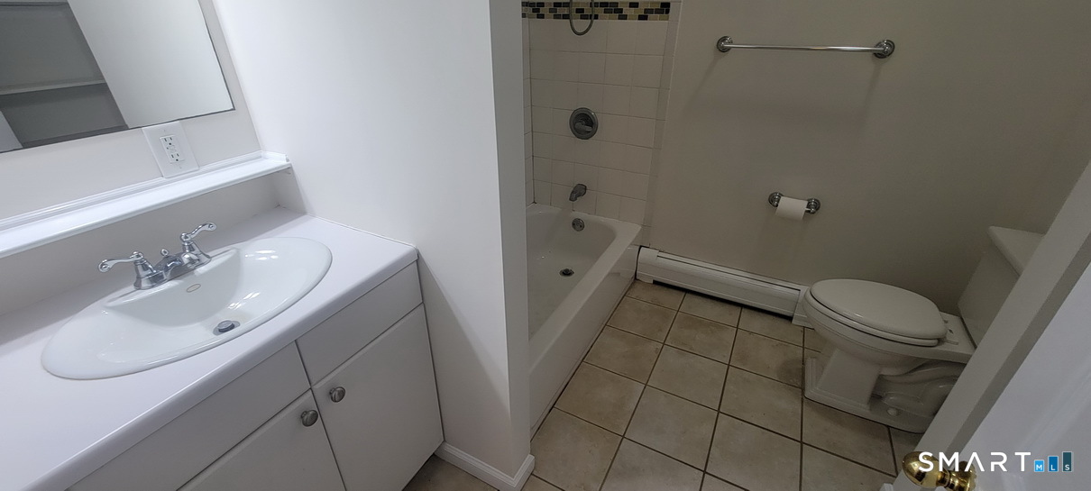 109 Wooster Street, Unit F Bethel, CT 06801 - Photo 8 of 11 a bathroom with a sink a toilet and shower