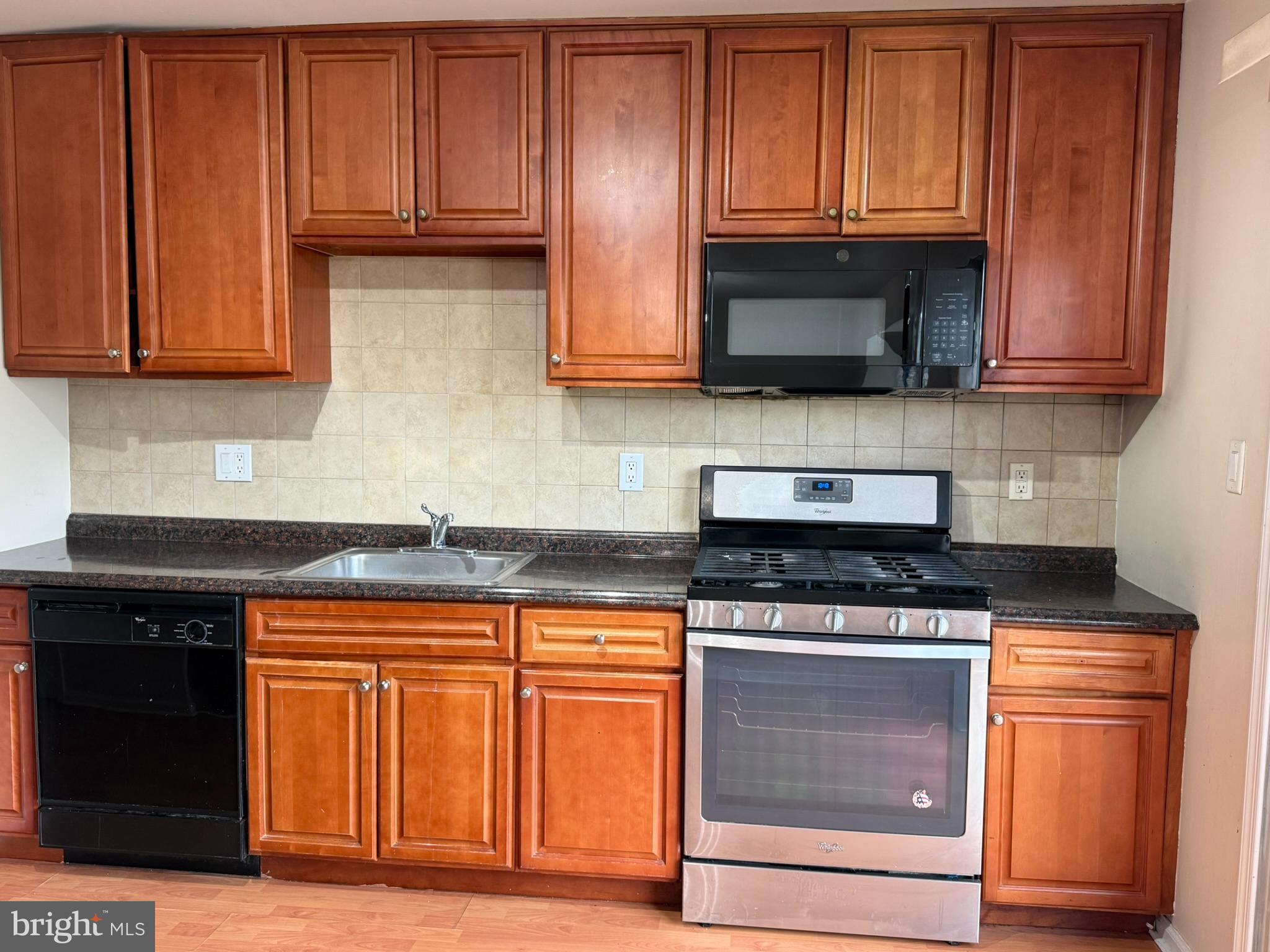 2605 Gramercy Way Mount Laurel, NJ 08054 - Photo 17 of 44 a kitchen with granite countertop wood cabinets and stainless steel appliances