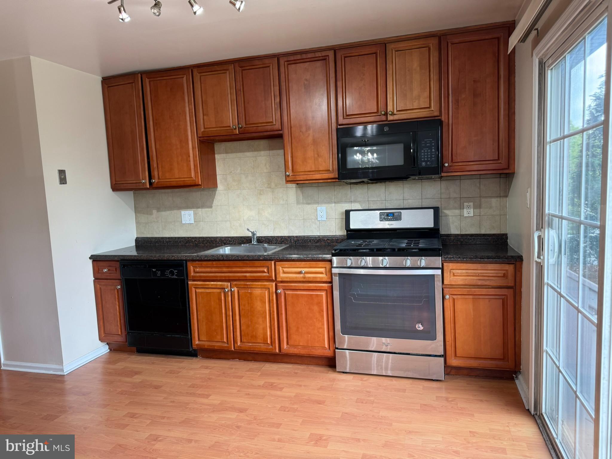 2605 Gramercy Way Mount Laurel, NJ 08054 - Photo 18 of 44 a kitchen with stainless steel appliances granite countertop wooden cabinets a stove a sink and a granite counter top