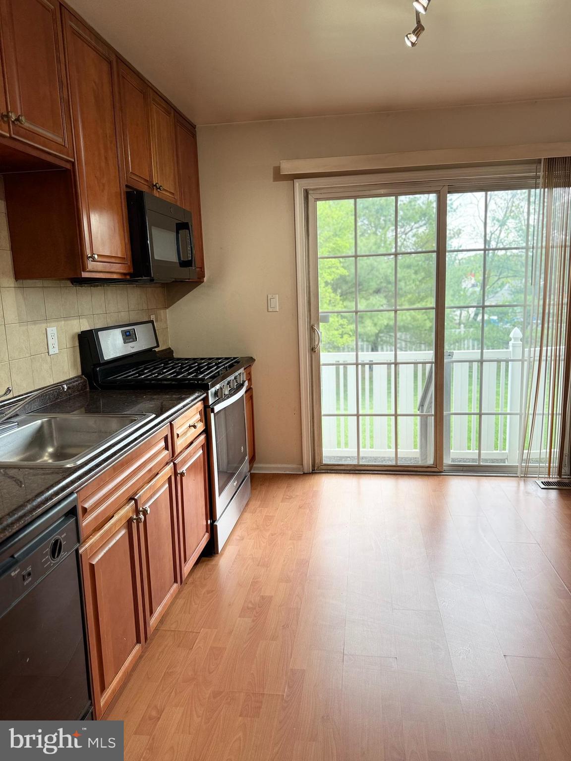 2605 Gramercy Way Mount Laurel, NJ 08054 - Photo 19 of 44 a kitchen with stainless steel appliances granite countertop a stove a sink and a microwave