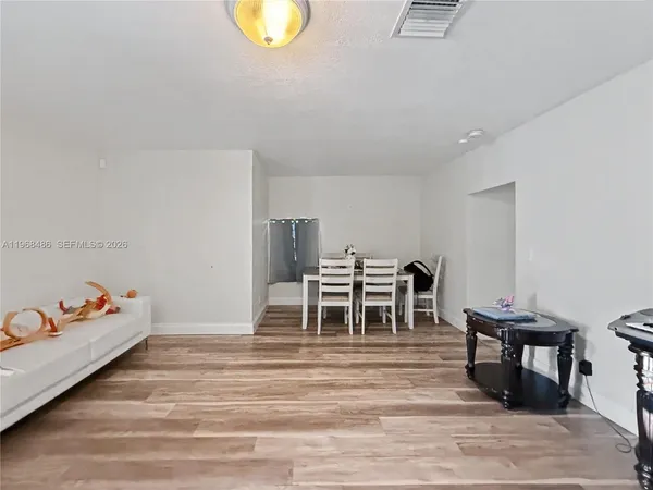 a bedroom with furniture and a wooden floor