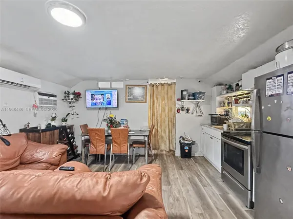 a living room with furniture and a kitchen view