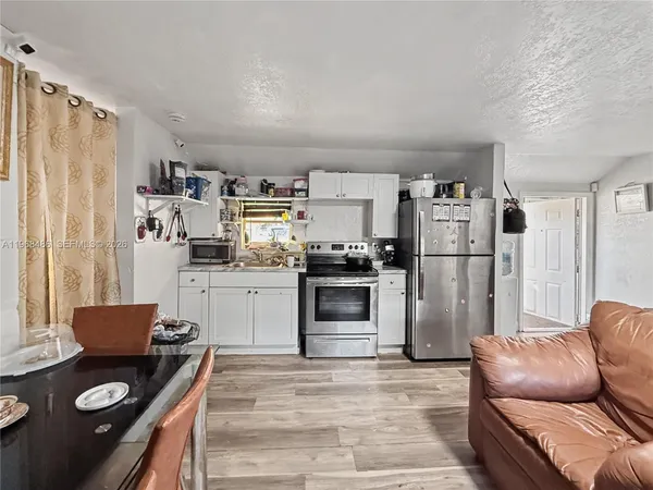 a kitchen with stainless steel appliances granite countertop a refrigerator sink and stove