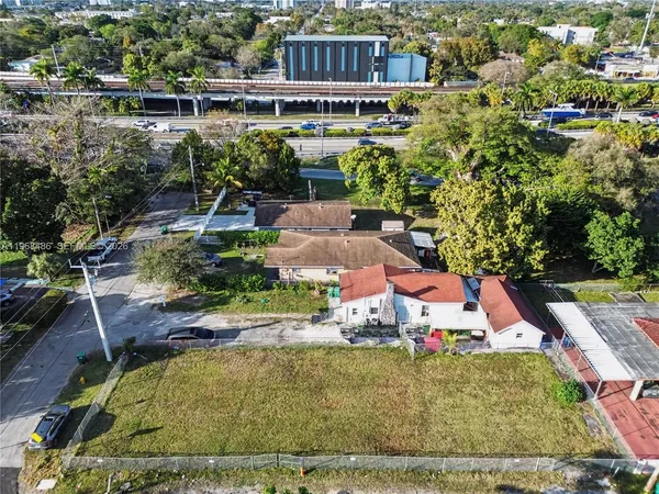 an aerial view of a house with a yard basket ball court and outdoor seating