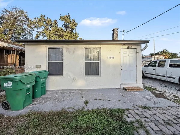 a view of a house with a backyard and porch