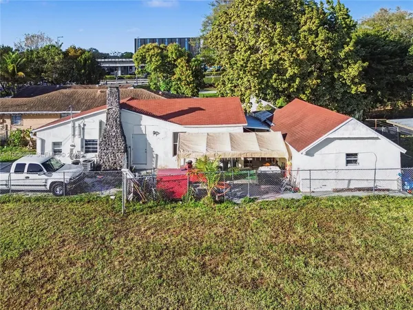 a view of a house with a yard and sitting area