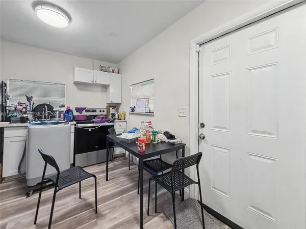 a view of a dining room with furniture and wooden floor